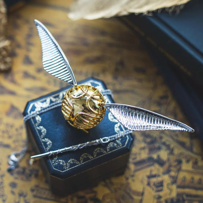 Gold and silver Snitch on a box with a textured background
