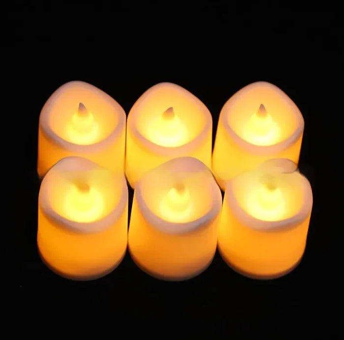 Set of six glowing candles on a black background