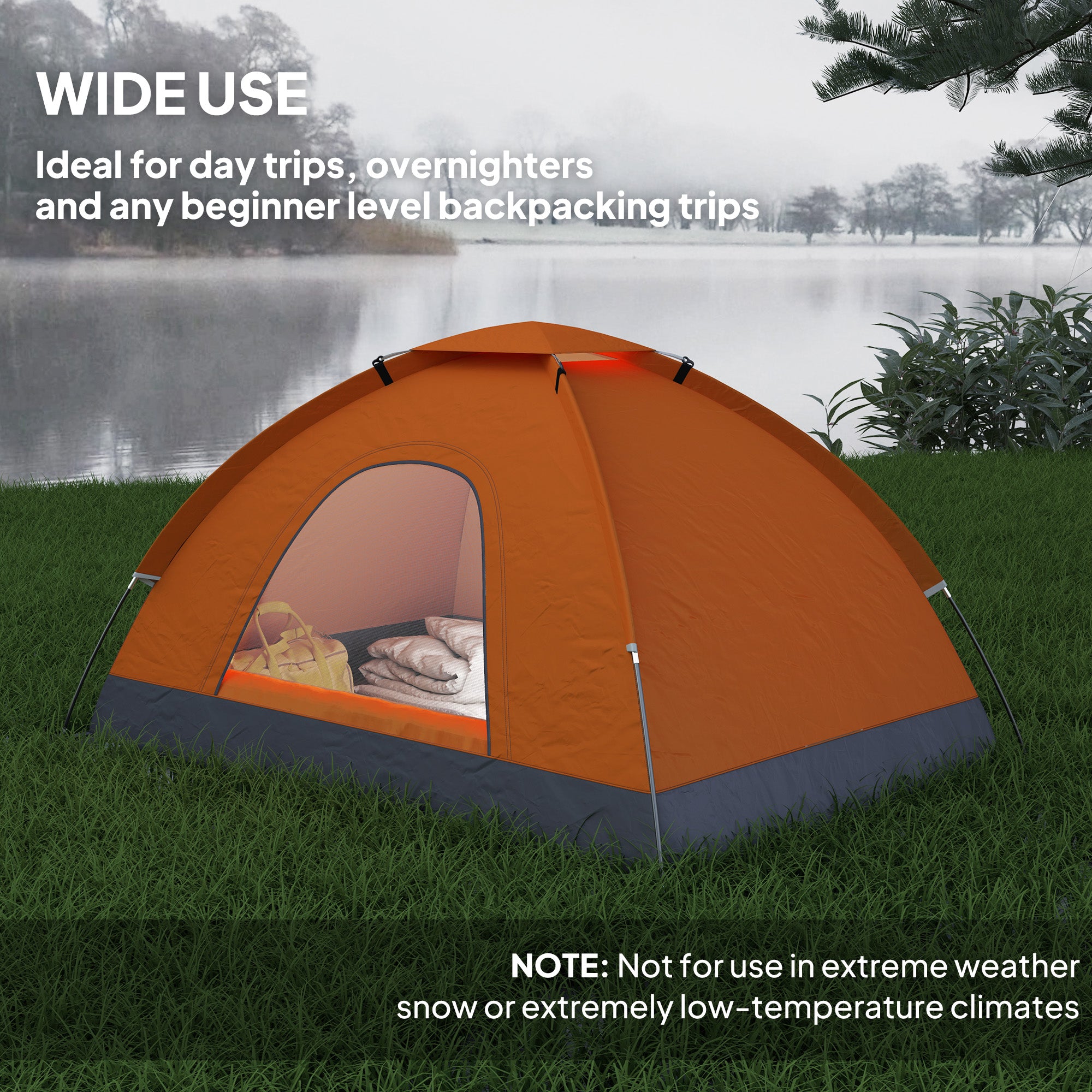 Orange camping tent on grass with a lake in the background