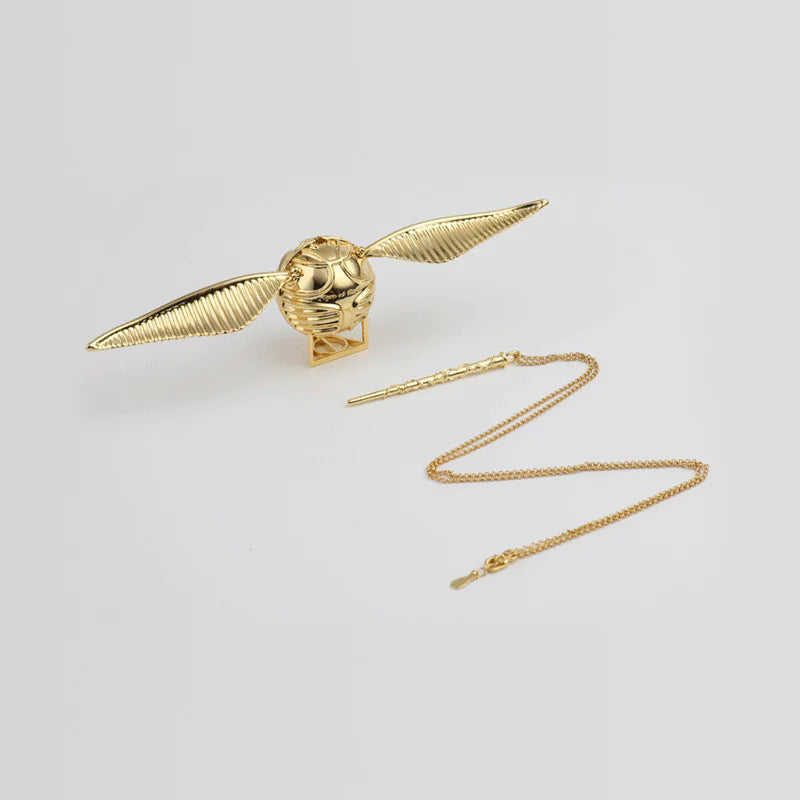 Gold necklace with a dragon-shaped pendant on a light gray background
