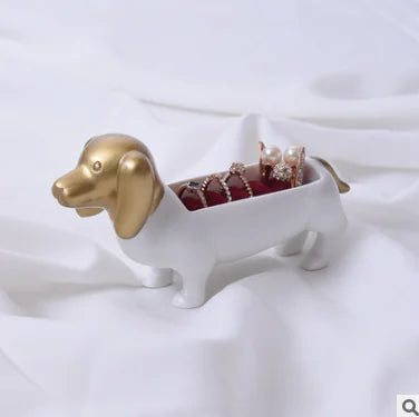 Dog-shaped jewelry holder with gold accents on a white background