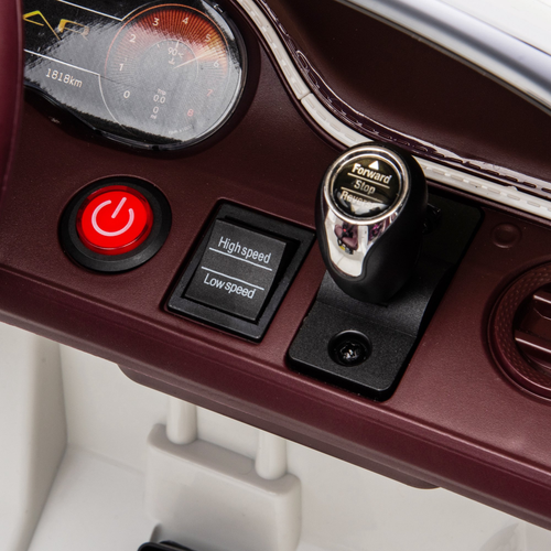 Control panel with red power button, speed controls, and a lever on a vehicle dashboard.