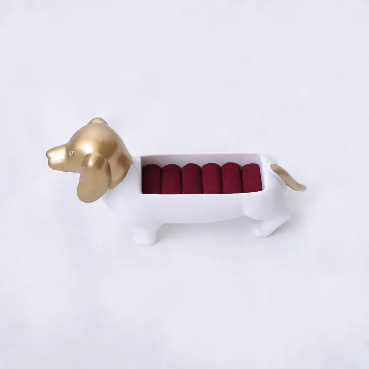 Gold dog-shaped object with red interior on a white background